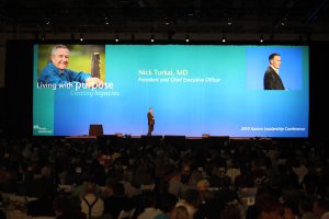 Nick Turkal giving a speech at the 2010 Aurora Health Care Meeting