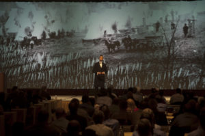 Abraham Lincoln impersonator in front of ultra-wide screen