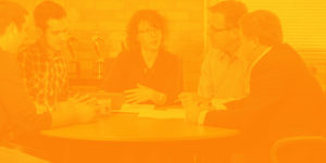 Tri-Marq employees discussing around table
