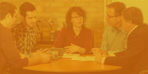 Tri-Marq employees discussing around table