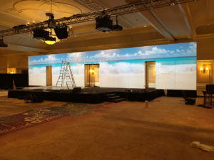 AEM 2015 background board with cutouts for presenters to enter+exit the stage