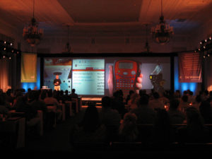 Keynote speaker using ultra-wide multi-screen display