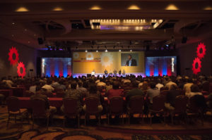 Audience view of keynote speakers ultra-wide presentation