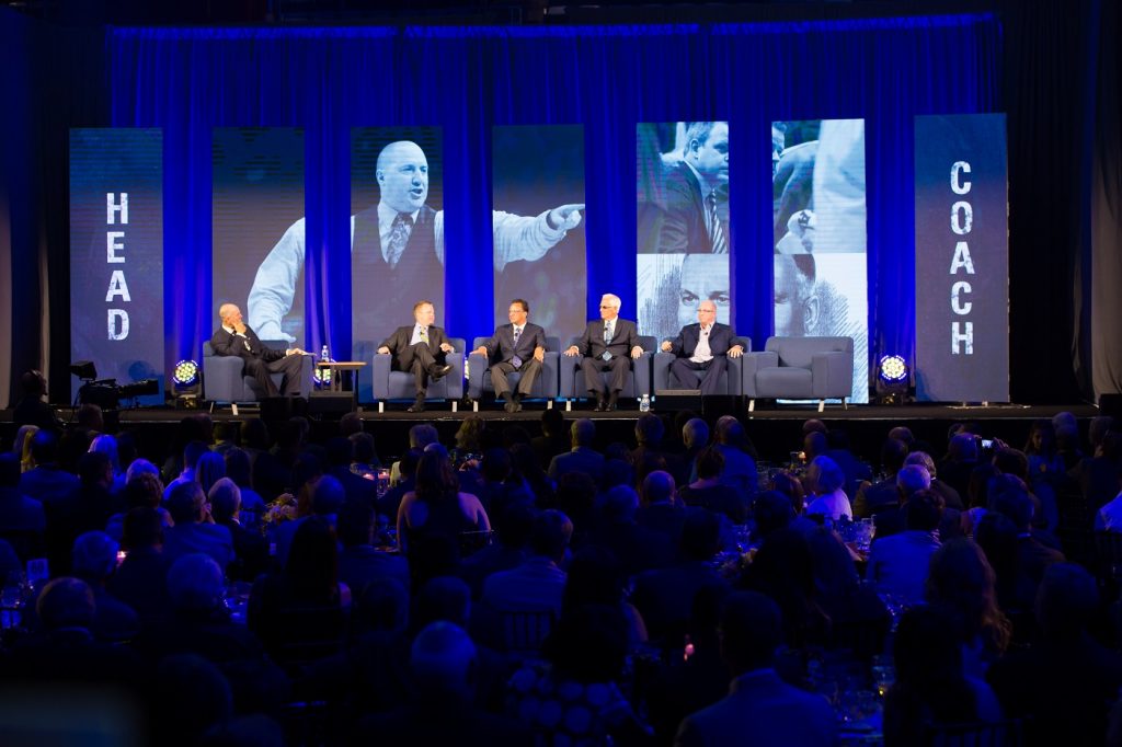 Panel on stage with LED video boards behind
