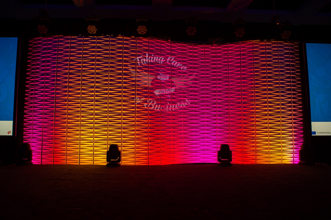 Curved wall of set tiles with LED lighting