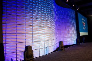 Curved tile wall set behind stage