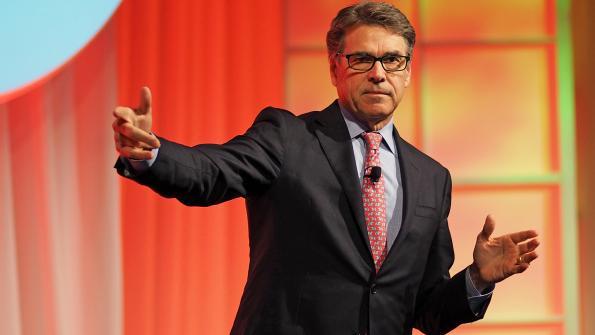 A photo of Rick Perry presenting at a recent Tri-Marq event.