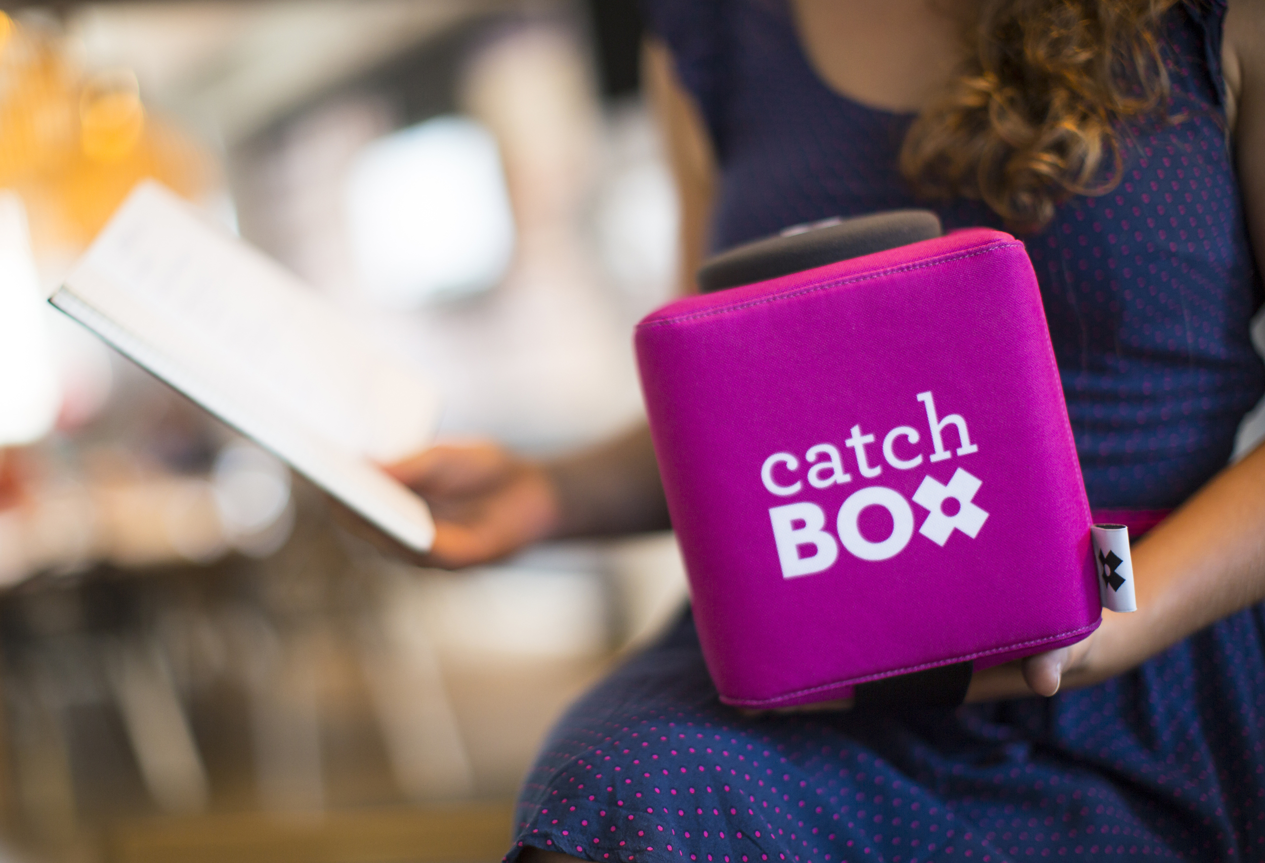 A photo of a woman holding the Catchbox.
