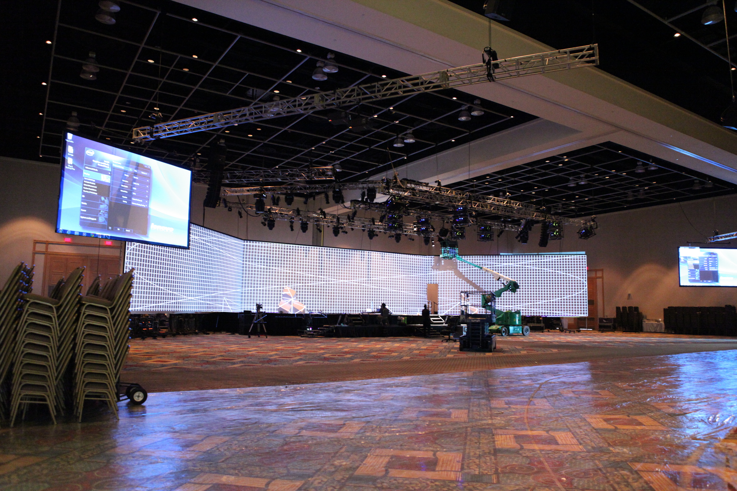 An image of Tri-Marq technical directors on a site survey, inspecting the wide screen before the event.