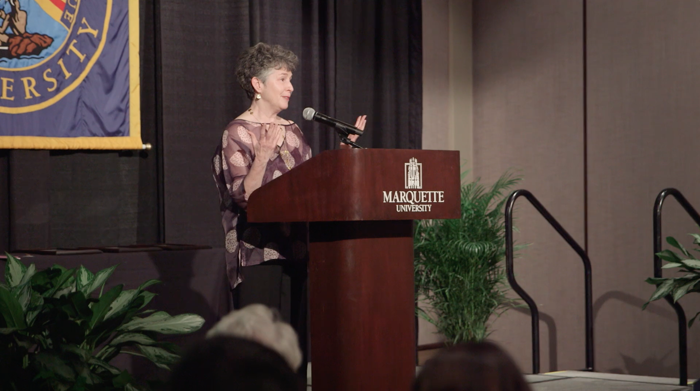 A woman speaking at a podium at the Marquette University Alumni National Awards - an event produced by Tri-Marq