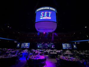 A view from the ground looking up at the branded material on the Jumbotron at the GMCC IceBreaker event in Madison, Wisconsin.