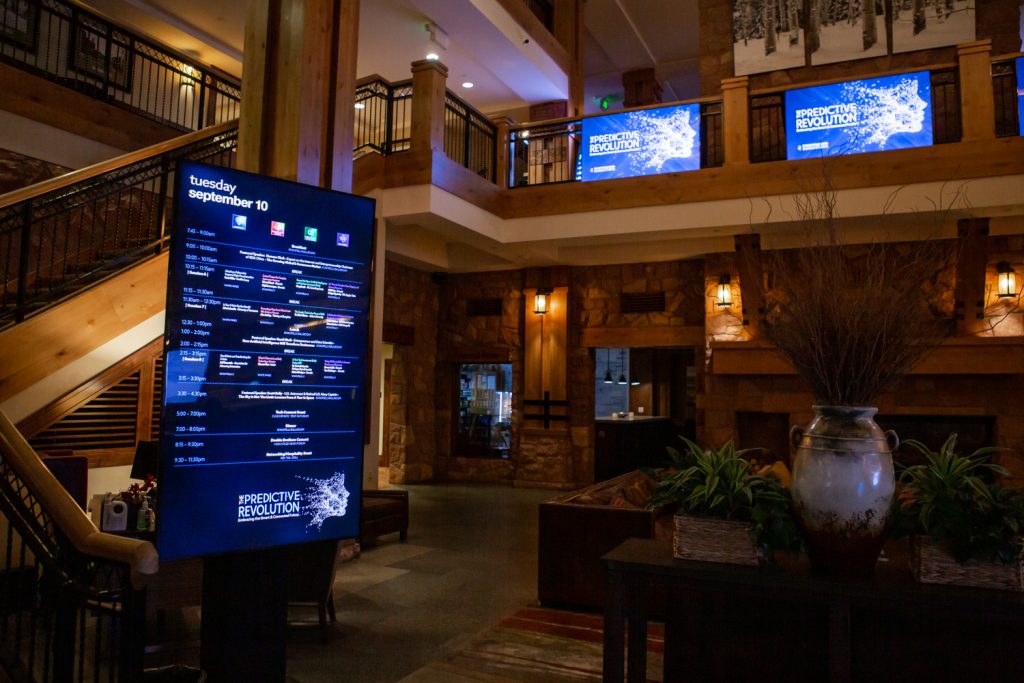 An image of a digital signage board being used as a schedule for an event. 