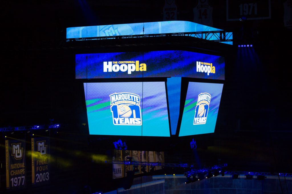 A view of the jumbotron at Fiserv Forum displaying graphics for the centennial hoopla celebration on its various LED boards