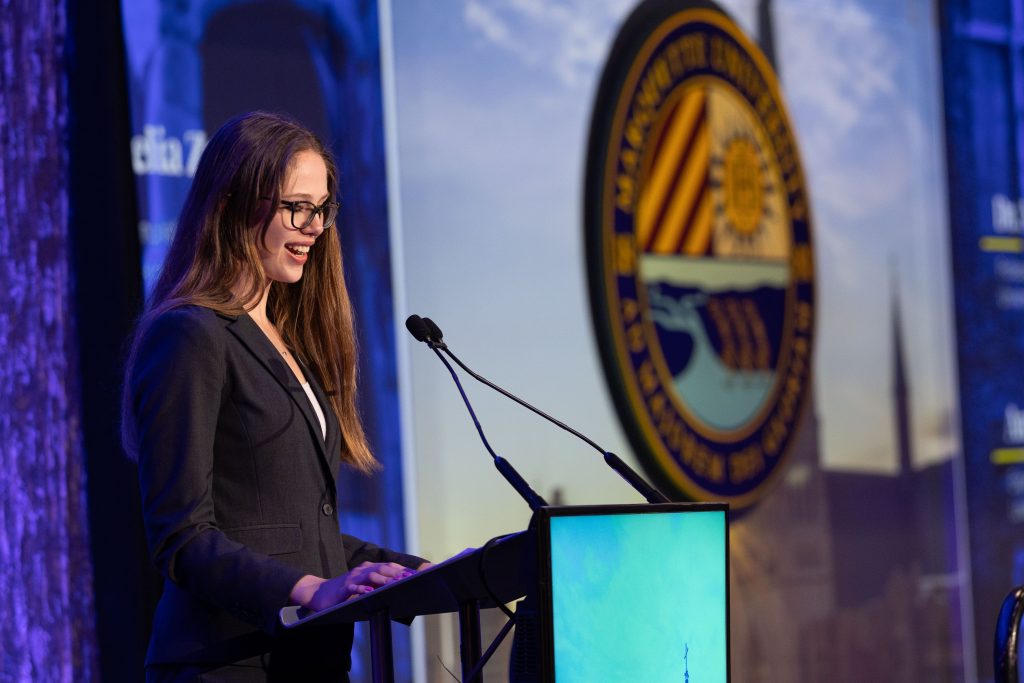 For gallery page: A photo from the Marquette University Scholarship Event. Features a student giving a seech on stage. 