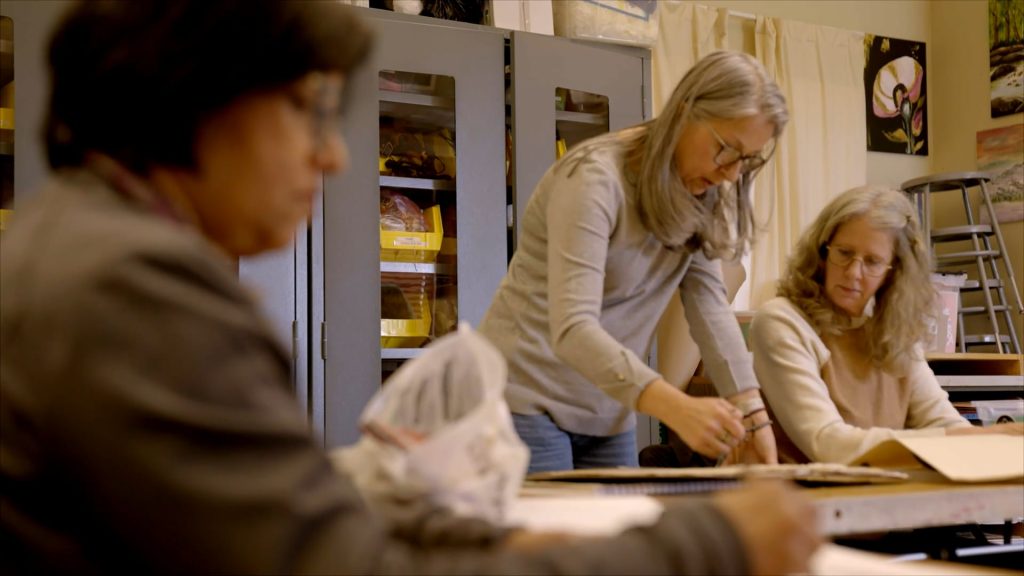 For gallery page: A thumbnail from the Sharon Lynne Wilson Center 2026 Big Event Video. Features an art teacher help adult students in the studio. 