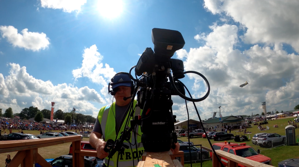 For gallery page: an image of a camreaman filming planes at EAA Airventure 2025 for the Megatron feed. 