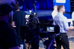 Event crew shot. On-site event video being recorded by a video director at a show.