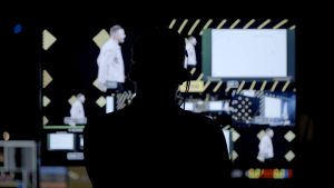 Event Crew Shot. A photo of a content producer looking at monitors as the even is taking place.