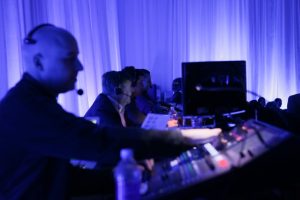 Event Crew Shot. Event Producers watch the event while ensuring the show is running smoothly.