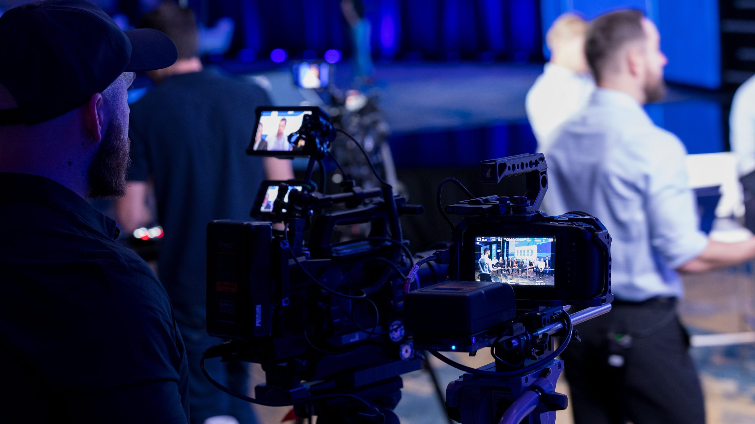 Event crew shot. On-site event video being recorded by a video director at a show.