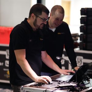 Event producer and executive producer work together behind the scenes at a Tri-Marq event.