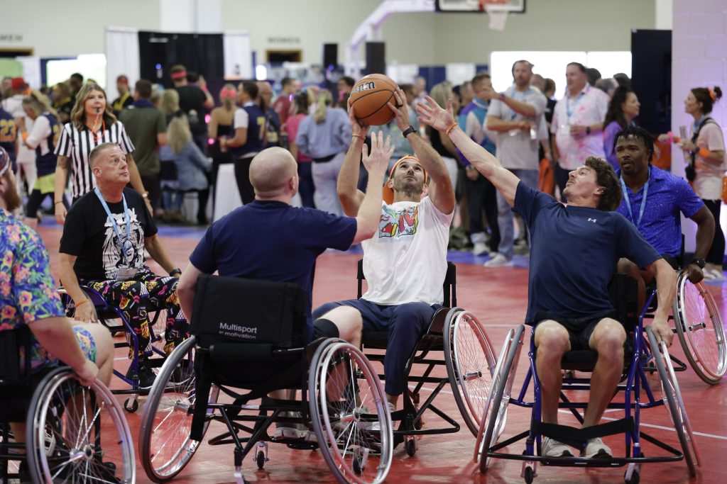 Event photography captures Numotion employees during a wheelchair basketball tournament at the annual Commerical Growth Summit.