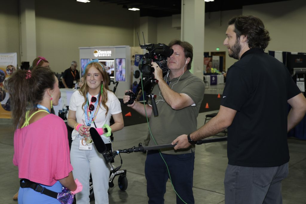 Tri-Marq producer and director of photography record an interview on-site at Numotion's 2026 Commercial Growth Summit.