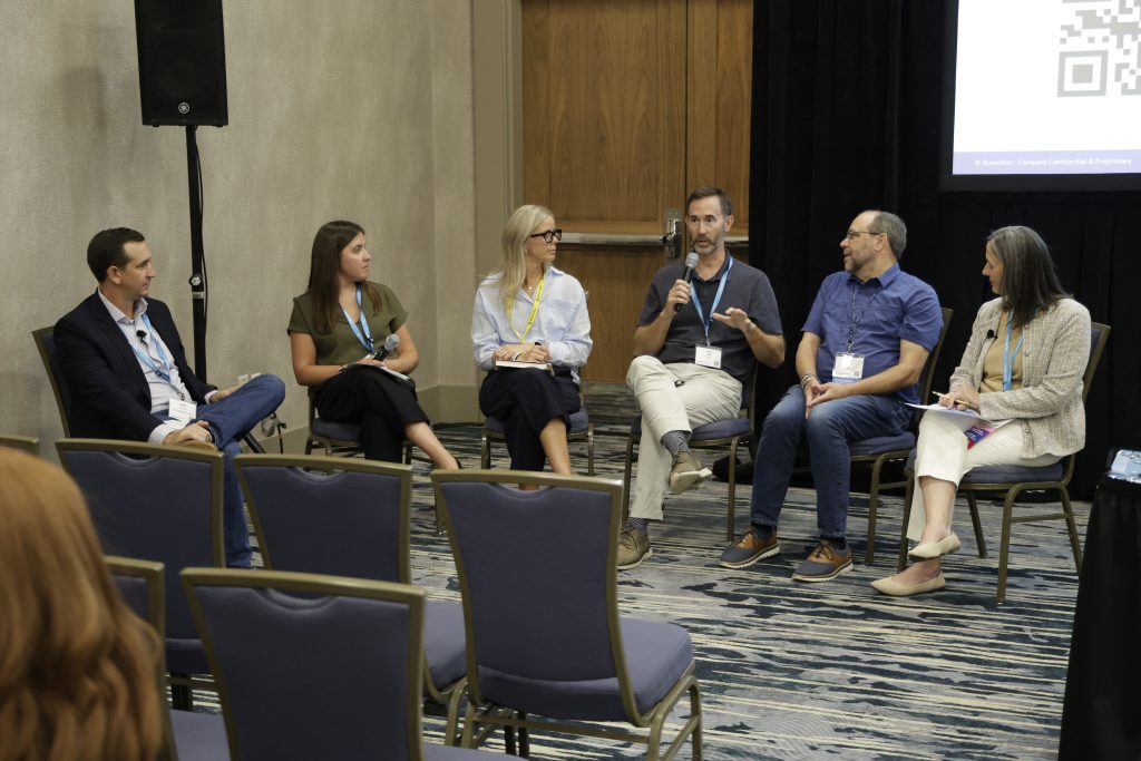 A group discussion occurring in a breakout room during the 2026 Numotion Commercial Growth Summit.