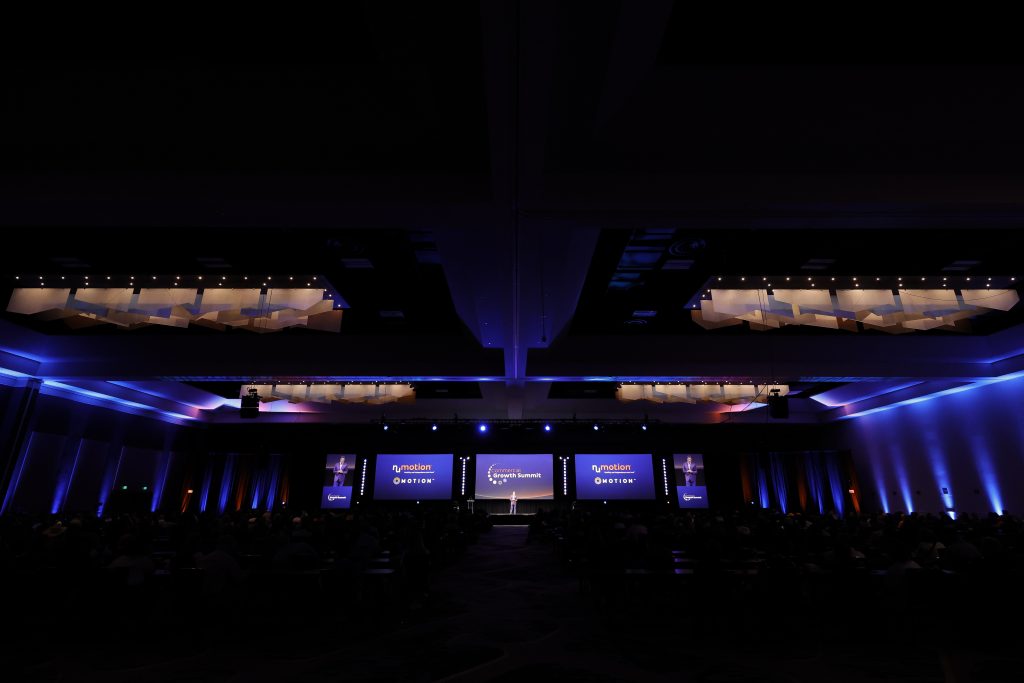 A back-of-house shot of the stage design ath the Numotion 2026 Commercial Growth Summit.