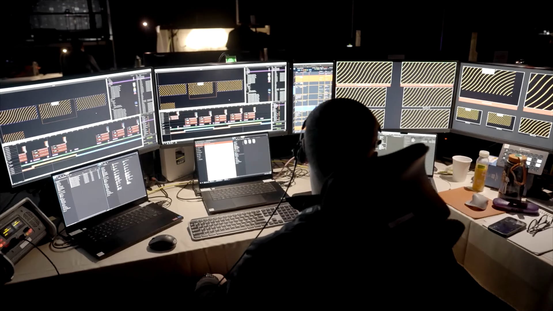 A media producer manages tghe content on-screen at Real Brokerage RISE 2025